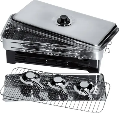 A stainless steel smoker with its lid open, revealing racks inside. A separate tray with three burner elements is shown in the foreground.