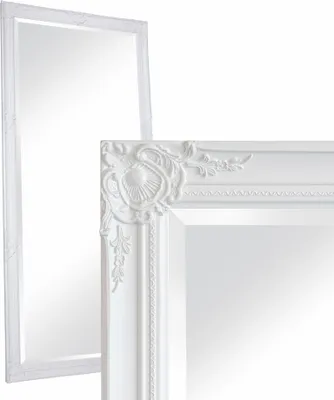 Two white baroque-style mirrors are shown against a white background. One mirror is in the foreground, angled to show its ornate frame and a portion of its reflective surface. The second mirror is in the background, positioned behind and to the left of the