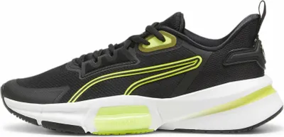 A side view of a black Puma PWRFRAME TR 3 WNS sneaker with neon yellow accents.