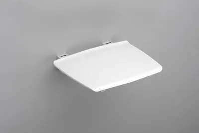 A white shower seat is mounted on a gray wall.