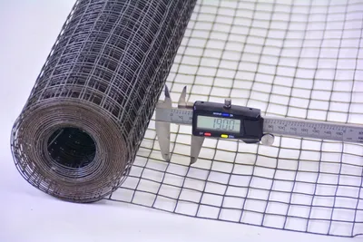A roll of wire mesh is shown with a caliper measuring the mesh size.