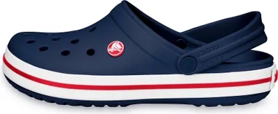 A side view of a navy blue Crocband clog with white and red stripes around the sole.