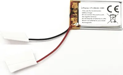 A small electronic component with wires attached, likely a battery or sensor, against a white background.
