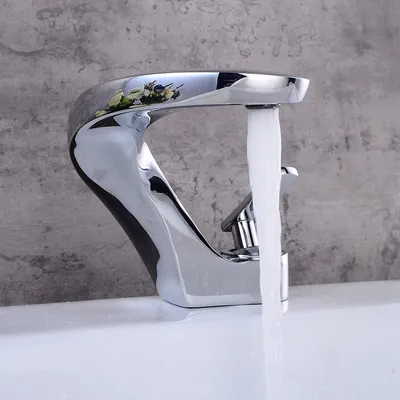 A chrome faucet with water running into a white sink.