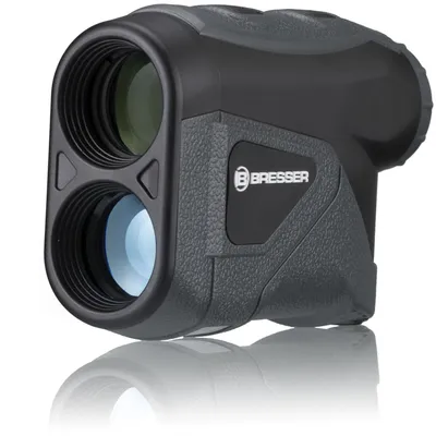 A product shot of a black and gray laser rangefinder with a white reflective surface underneath.