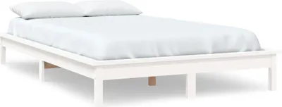 A white bed frame with white bedding and pillows, shown from a side-diagonal angle.
