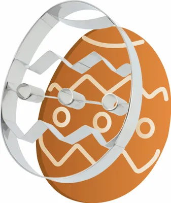 A cookie cutter in the shape of an Easter egg is placed over a decorated Easter egg.