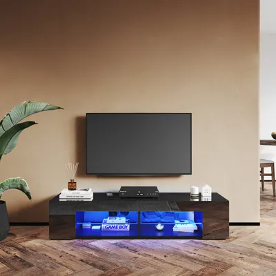 A modern living room with a TV stand featuring RGB lighting.