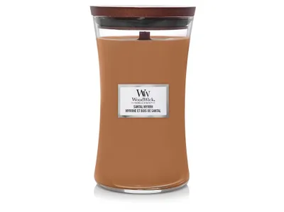 A WoodWick candle in a glass jar with a wooden lid.
