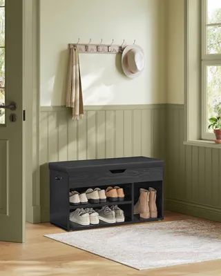 An entryway with a shoe bench and coat rack.