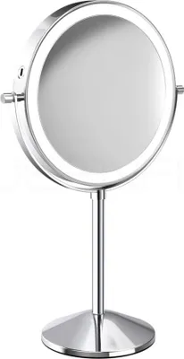 A silver, illuminated makeup mirror on a stand against a white background.
