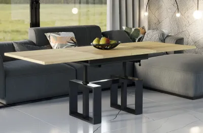 A modern living room with a sofa, coffee table, and ottoman.