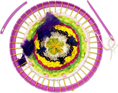 A circular weaving loom with colorful yarn and embellishments.