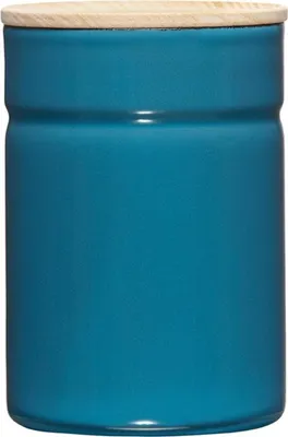 A close-up studio shot of a blue ceramic storage jar with a wooden lid.