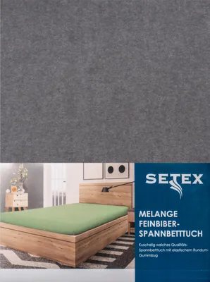 A product image showing a bed with a green fitted sheet and a dark grey background.