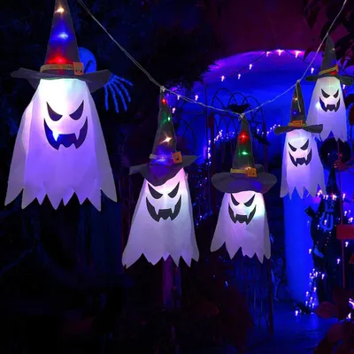 Halloween decorations hanging outdoors at night.