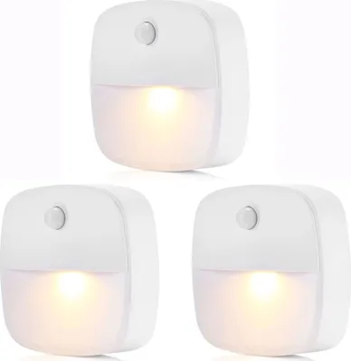 Three white LED night lights with motion and dusk sensors are arranged in a triangular formation against a white background.