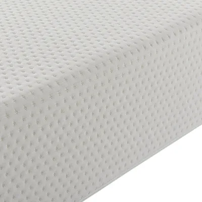 A close-up, angled view of a beige mattress with a textured surface.