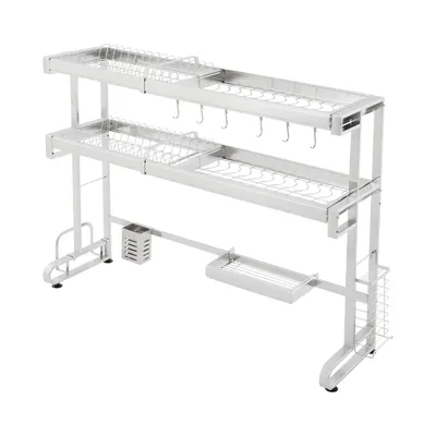 A two-tier stainless steel dish drying rack with various compartments and hooks, shown against a white background.