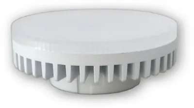 A white, round LED light fixture with a ribbed heat sink base.