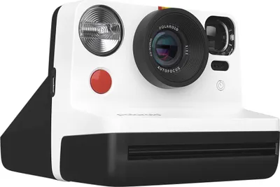 A white and black Polaroid instant camera is shown from the front.