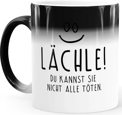 Produktbild von Zaubertasse Farbwechsel Tasse lustiger Spruch lächle du kannst sie nicht alle töten Smiley Bürotasse MoonWorks® weiß Magic-Tasse