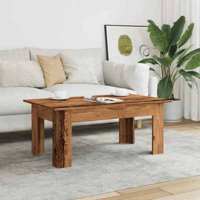 A living room scene with a sofa, coffee table, and plant.