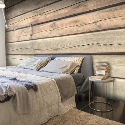 A bedroom scene with a bed and a wooden wall.