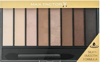 A top-down view of an eyeshadow palette with multiple shades and an applicator.