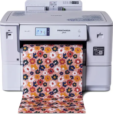 A Brother Textildrucker PrintModa Studio HL-JF1 printing a patterned fabric.