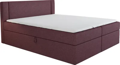 A boxspring bed with a headboard and mattress.