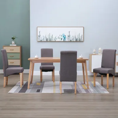 A dining room scene with a table and chairs, a dresser, and wall art.