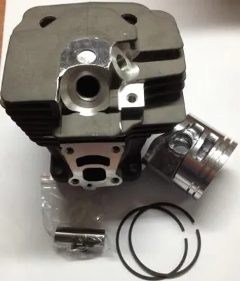 A close-up view of a chainsaw cylinder and piston kit on a white background.
