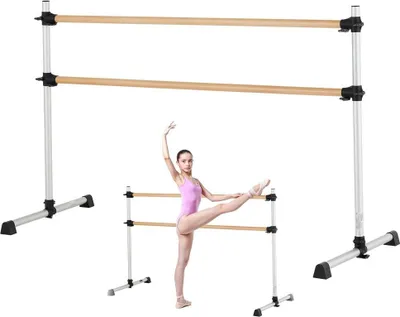 A ballet dancer is practicing at a ballet barre.