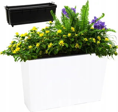 A white planter box filled with yellow flowers, green foliage, and purple accents, with a black insert shown above.