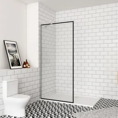 A modern bathroom with a walk-in shower, toilet, and tiled walls and floor.
