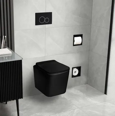 A modern black wall-mounted toilet in a bathroom with light gray tiled walls and floor.