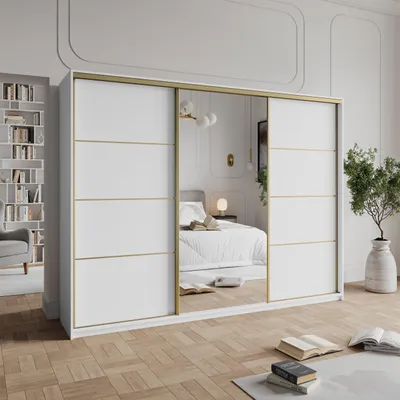 A bedroom scene with a large sliding door wardrobe as the main focus, reflecting a bed and other bedroom elements.