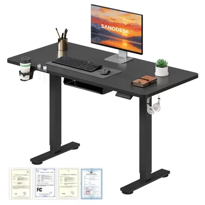 A black standing desk with a monitor, keyboard, mouse, and accessories.