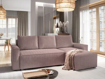 A modern living room with a pink sectional sofa, ottoman, and decorative elements.