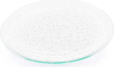 A pile of small white beads in a glass dish.