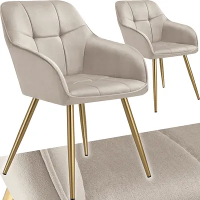 Two beige upholstered chairs with gold legs are shown against a white background.