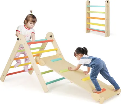 Two toddlers playing on a wooden climbing triangle with a slide.