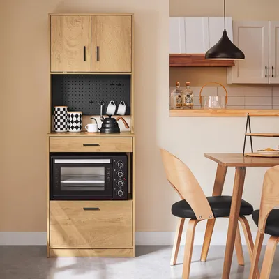 A kitchen cabinet with a microwave and storage, next to a dining table and chairs.