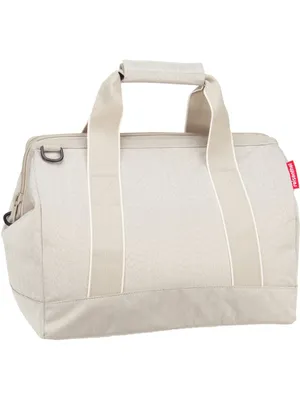 A studio shot of a beige duffel bag against a white background.