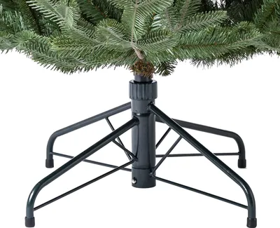 Close-up of the base and lower branches of an artificial Christmas tree.