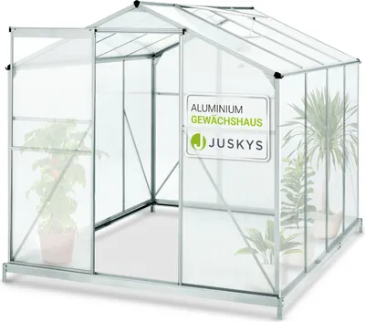 An empty aluminum greenhouse with a clear roof and walls, featuring an open door and a sign with the brand name.