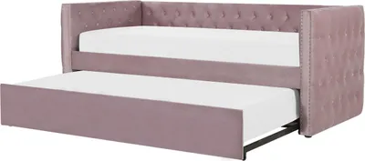 A pink velvet daybed with a pull-out trundle bed, both with white mattresses, shown against a white background.