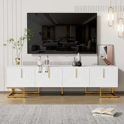 A white TV stand with gold legs is shown in a living room setting, with a large TV mounted above it.