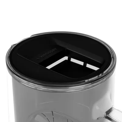 Close-up view of the lid of a clear container with a black insert.